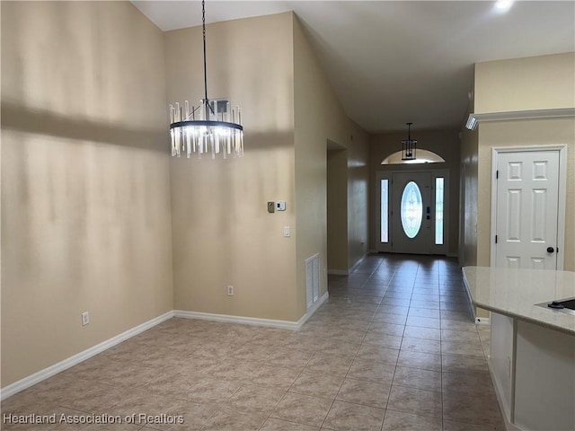 entrance foyer featuring light tile patterned floors and a notable chandelier