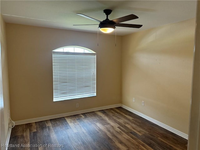 unfurnished room with ceiling fan and dark hardwood / wood-style flooring