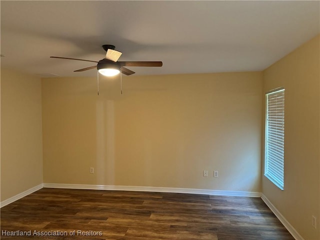 empty room with ceiling fan and dark hardwood / wood-style floors