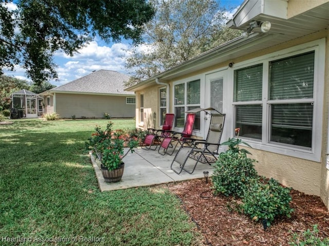 exterior space with a lawn, a patio area, and a lanai