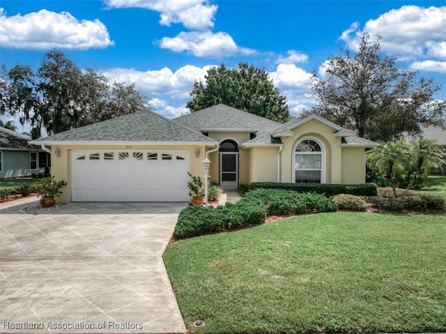 ranch-style home featuring a garage and a front lawn