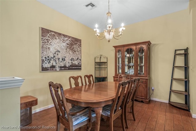 dining room featuring a chandelier and dark wood-type flooring