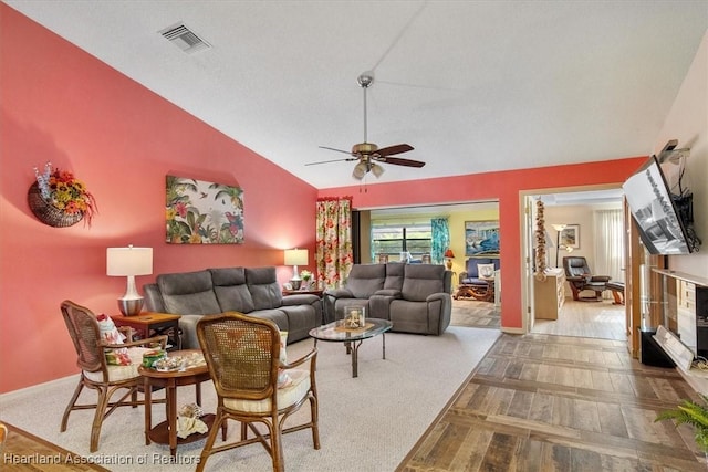 living room featuring ceiling fan, parquet flooring, a textured ceiling, and vaulted ceiling