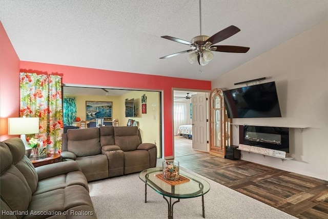 living room with dark hardwood / wood-style flooring, a textured ceiling, ceiling fan, and lofted ceiling