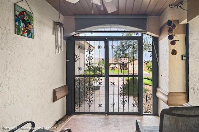 entryway featuring ceiling fan and wooden ceiling