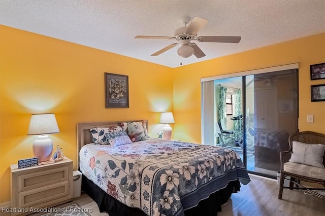 bedroom featuring access to exterior, a textured ceiling, and ceiling fan