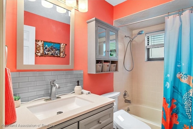 full bathroom featuring decorative backsplash, shower / tub combo, vanity, and toilet