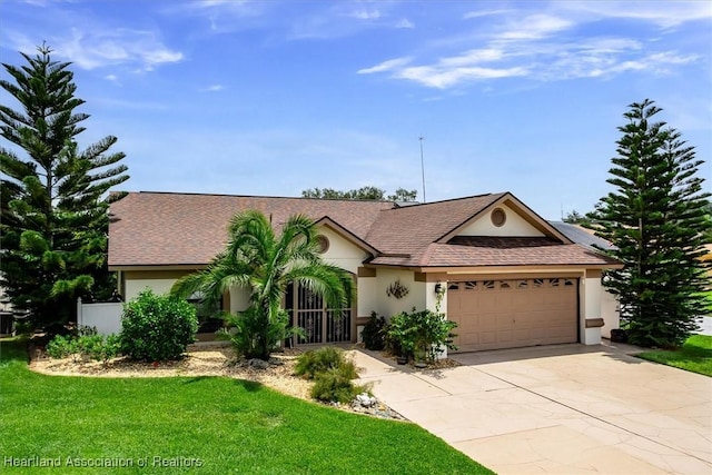 single story home featuring a front lawn and a garage