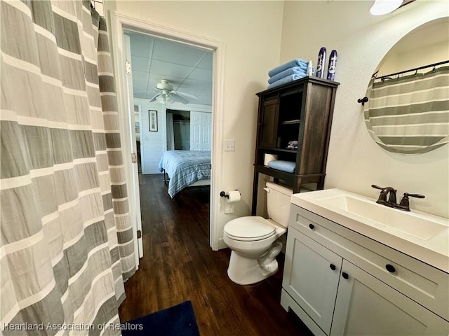 bathroom featuring wood-type flooring, vanity, toilet, and ceiling fan