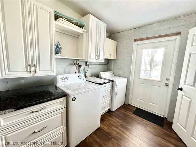 laundry room with cabinets, dark hardwood / wood-style floors, and washer and clothes dryer