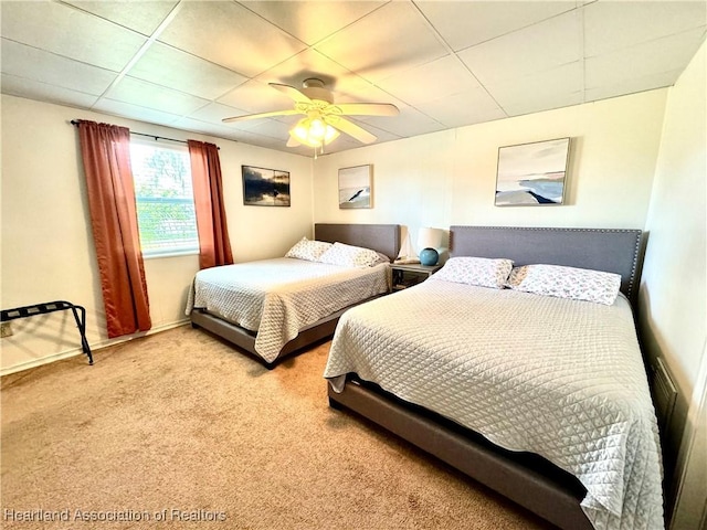 bedroom featuring a paneled ceiling, ceiling fan, and light carpet