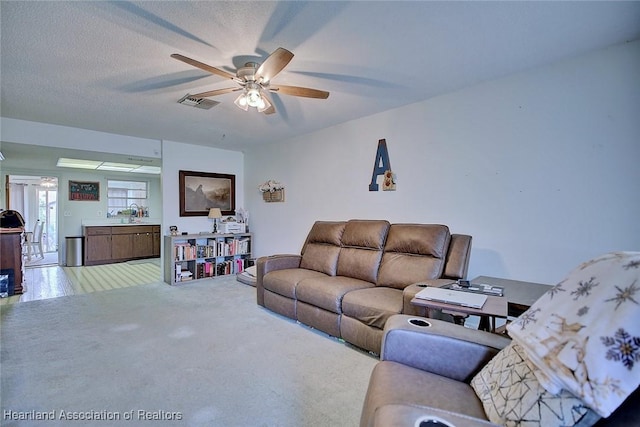22 W Raymond St, Avon Park, FL 33825 - living area featuring a ceiling fan and carpet floors