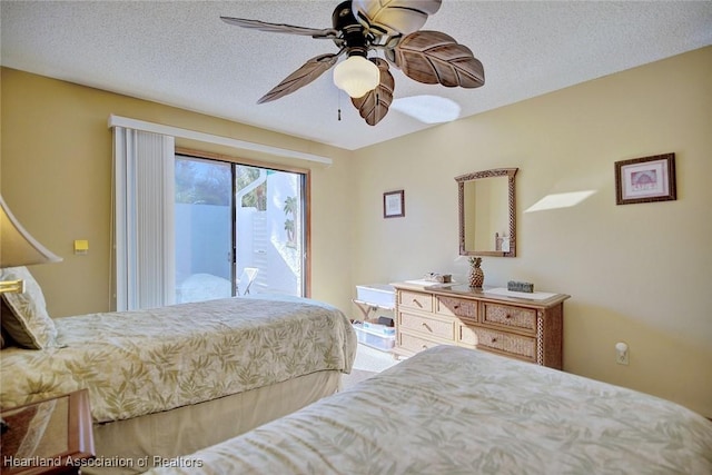 bedroom with access to exterior, a textured ceiling, and ceiling fan