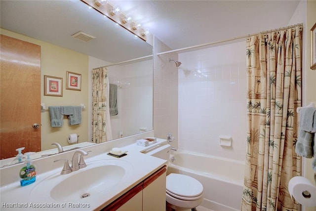 full bathroom with shower / bath combo, toilet, and vanity