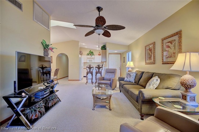 carpeted living room featuring ceiling fan and lofted ceiling