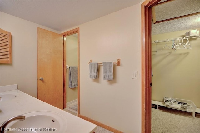 bathroom with vanity and a textured ceiling