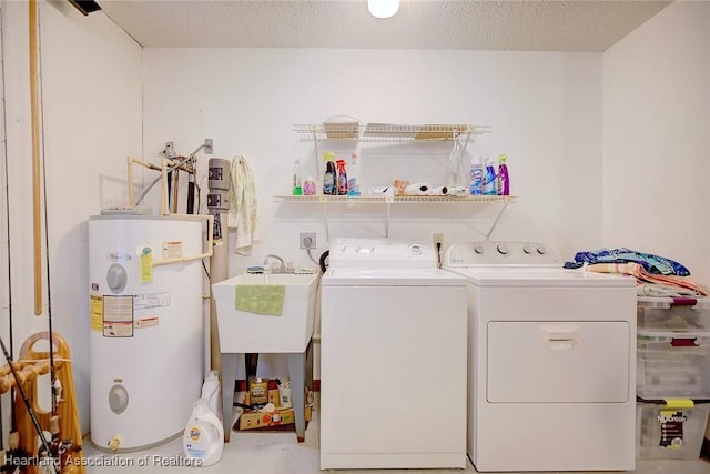 laundry room featuring a textured ceiling, separate washer and dryer, and water heater