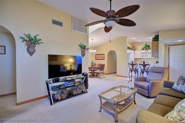 living room with ceiling fan with notable chandelier and light carpet