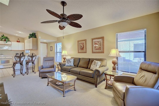 carpeted living room featuring ceiling fan and lofted ceiling