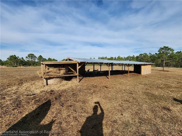 exterior space with a rural view and an outdoor structure