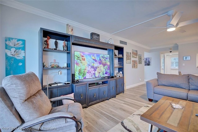living area featuring a ceiling fan, visible vents, crown molding, and light wood-style flooring