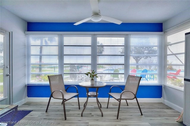 sunroom with a healthy amount of sunlight and ceiling fan