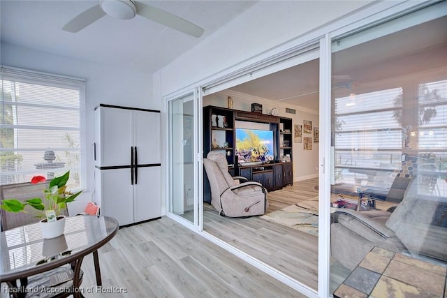 doorway featuring light wood-style floors and ceiling fan