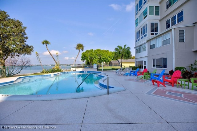 community pool featuring a patio area and fence