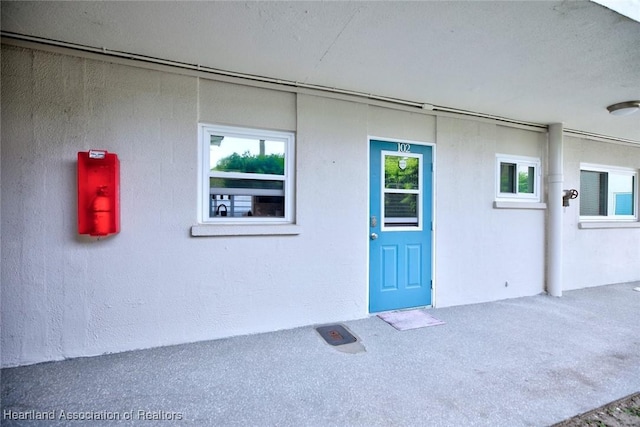 view of exterior entry with stucco siding