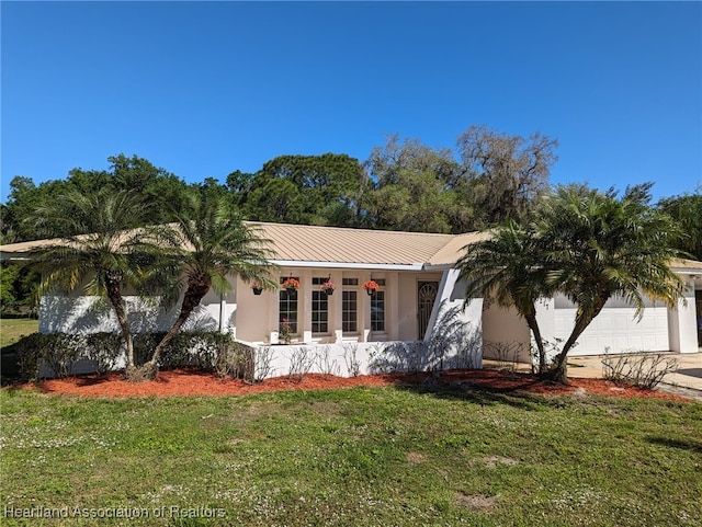 ranch-style home with a garage and a front lawn