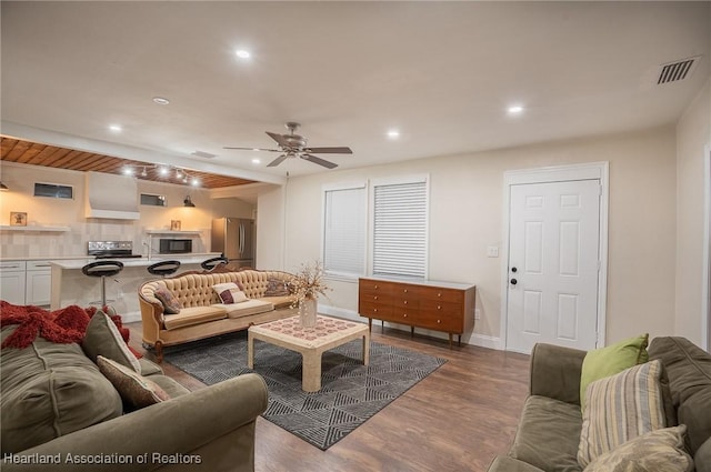 living room with ceiling fan and dark hardwood / wood-style flooring