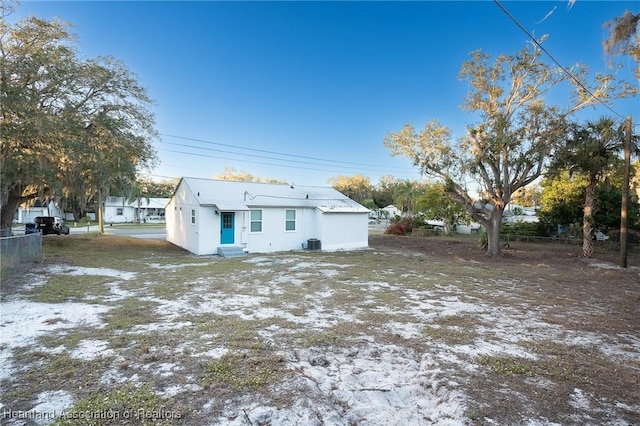 snow covered property featuring central AC unit