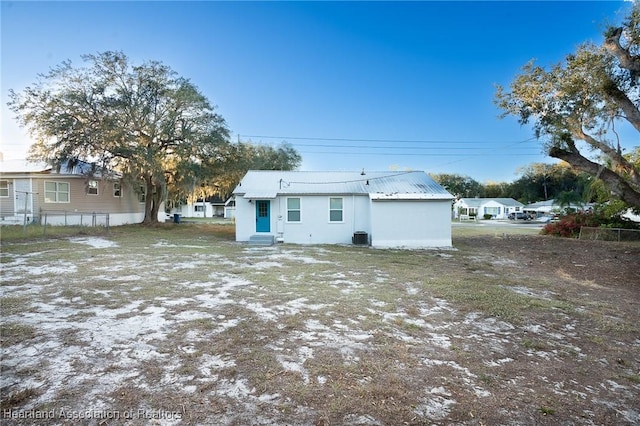 back of house featuring central air condition unit