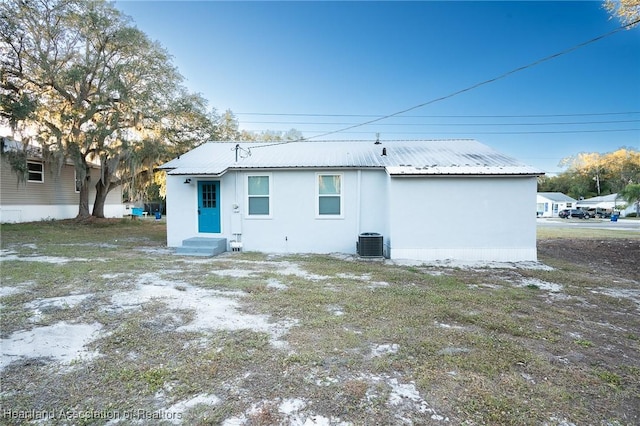 rear view of house with central AC unit