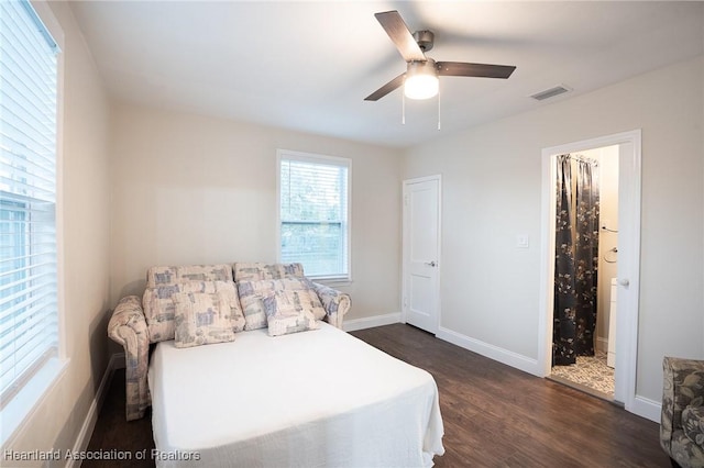 bedroom featuring connected bathroom, ceiling fan, and dark hardwood / wood-style flooring