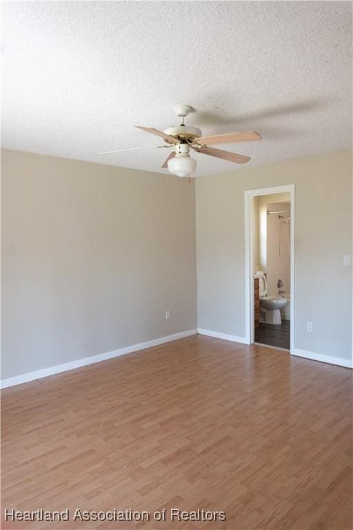 unfurnished room featuring ceiling fan, wood-type flooring, and a textured ceiling