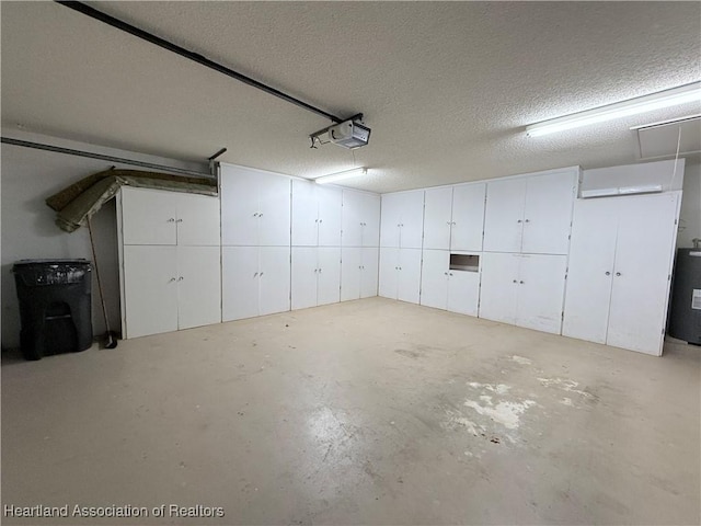 garage with a garage door opener and electric water heater