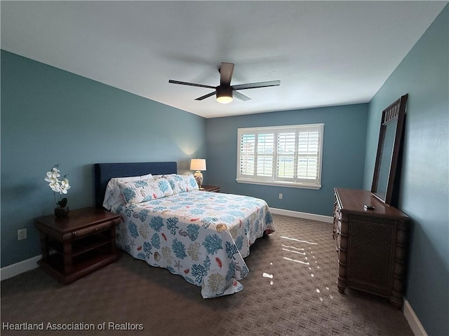 bedroom featuring ceiling fan, dark colored carpet, and baseboards