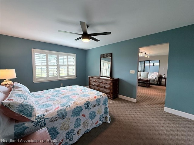 bedroom featuring a ceiling fan, carpet, and baseboards