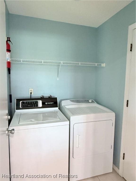 laundry area featuring laundry area, light tile patterned flooring, and independent washer and dryer