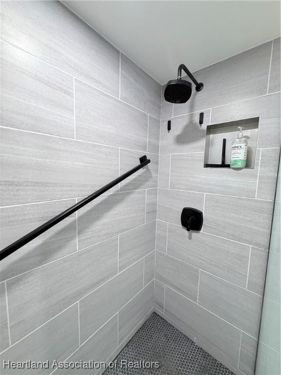 bathroom with a tile shower