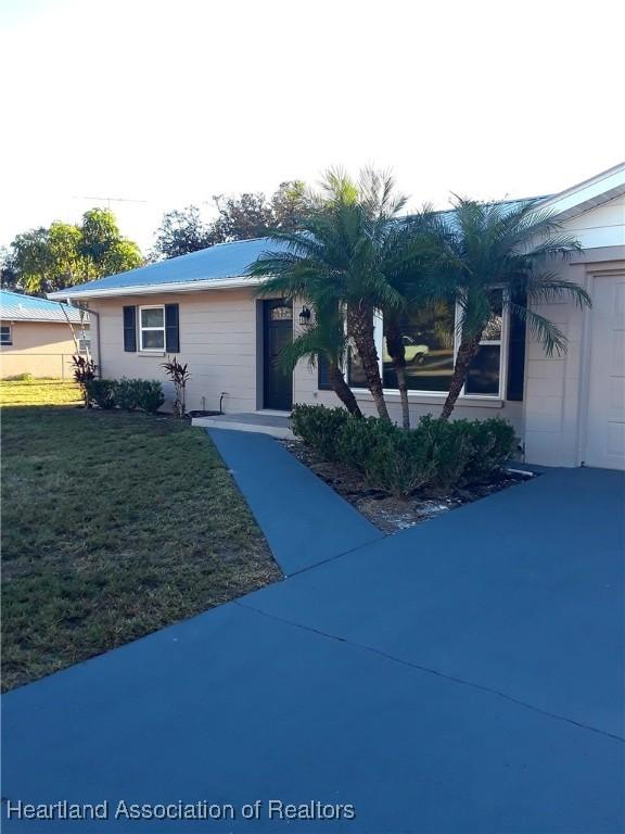 view of front of property with a garage and a front lawn