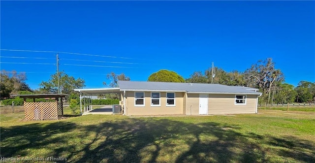 view of outdoor structure with a yard and central AC unit