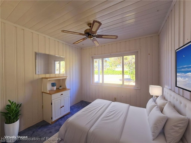 bedroom featuring crown molding, wooden ceiling, ceiling fan, and dark colored carpet