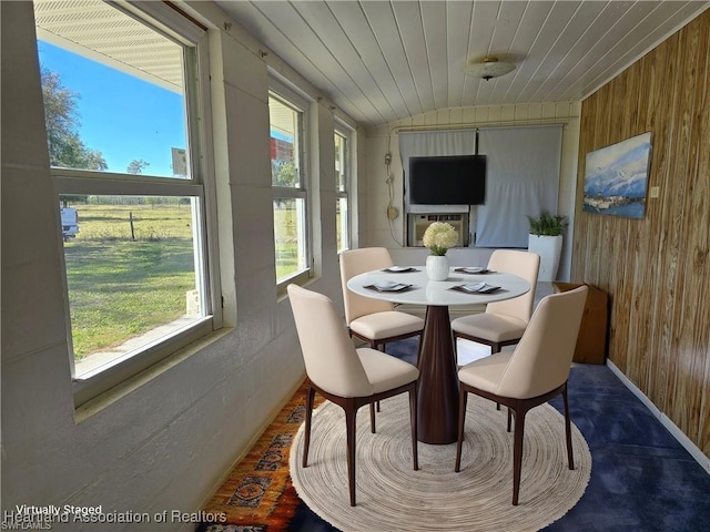 sunroom / solarium with plenty of natural light, lofted ceiling, and wooden ceiling