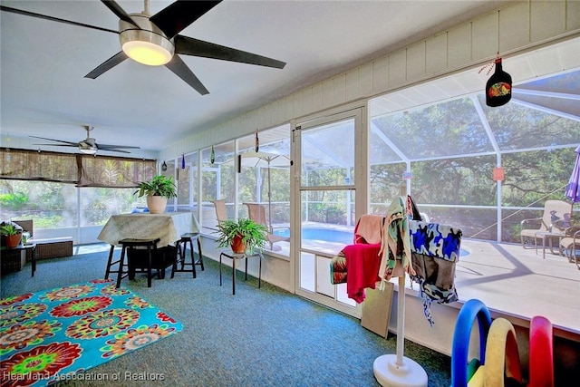 sunroom featuring plenty of natural light and ceiling fan