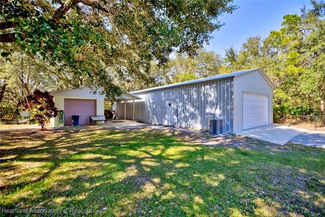 garage featuring central AC and a lawn