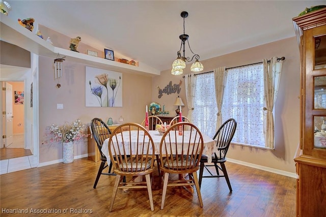 dining space with lofted ceiling and hardwood / wood-style floors