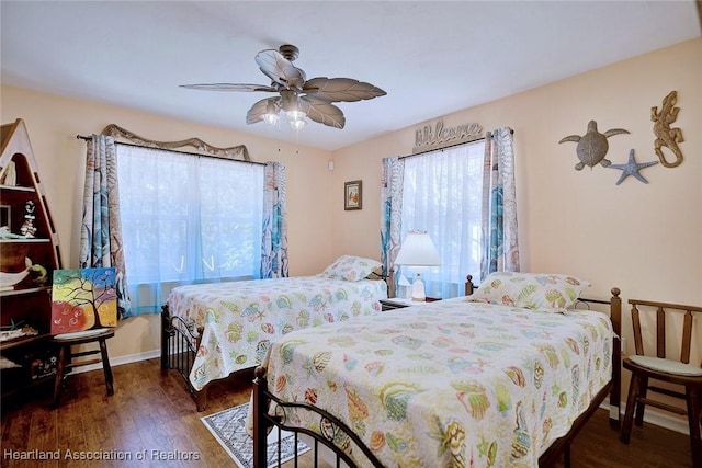 bedroom with ceiling fan and dark hardwood / wood-style flooring