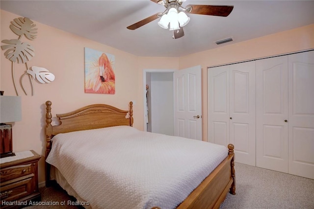 carpeted bedroom with a closet and ceiling fan